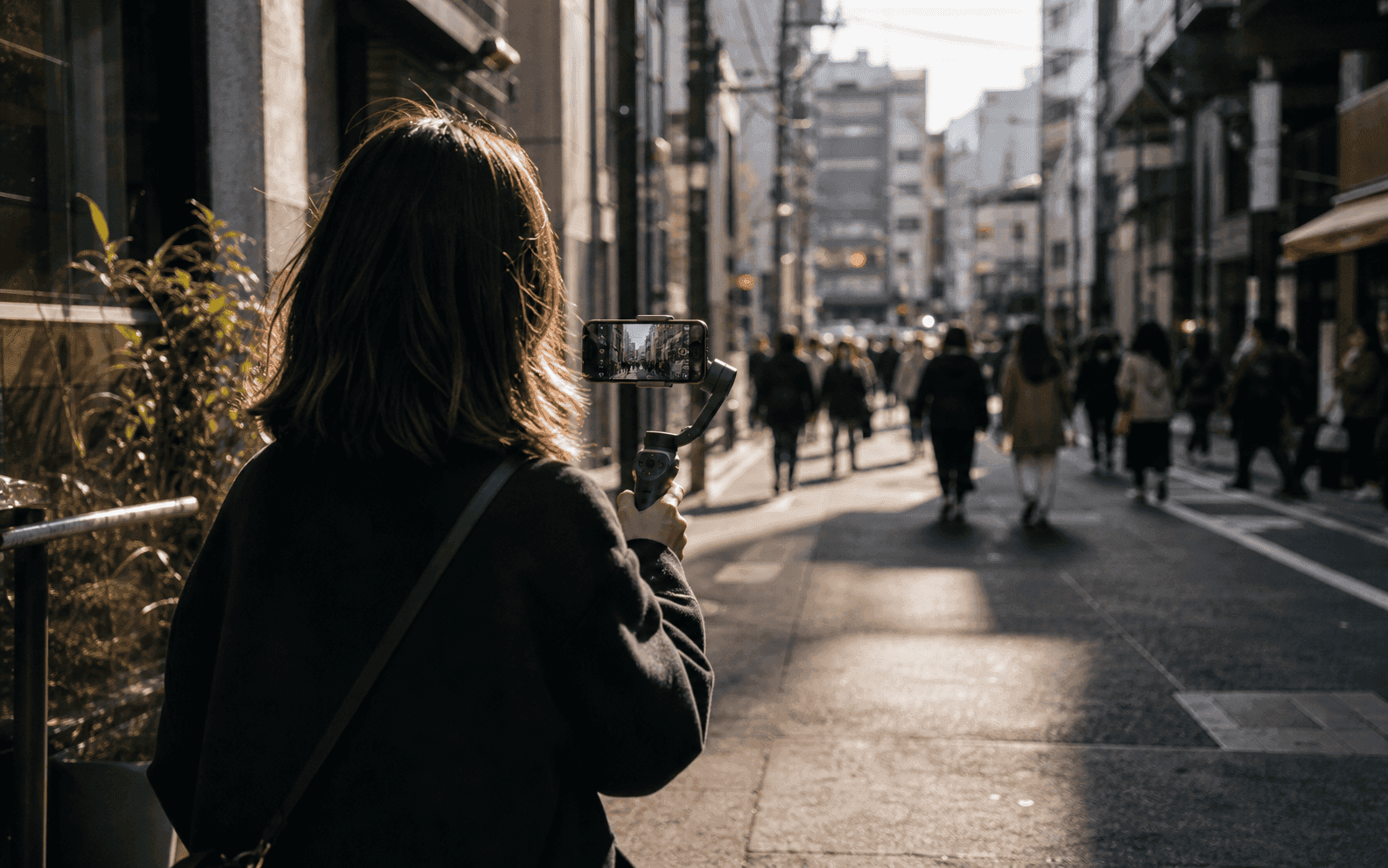 Creator filming on a Shibuya backstreet at golden hour